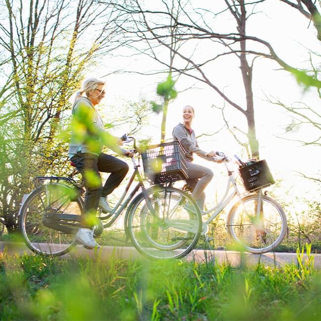 Two women bike riding