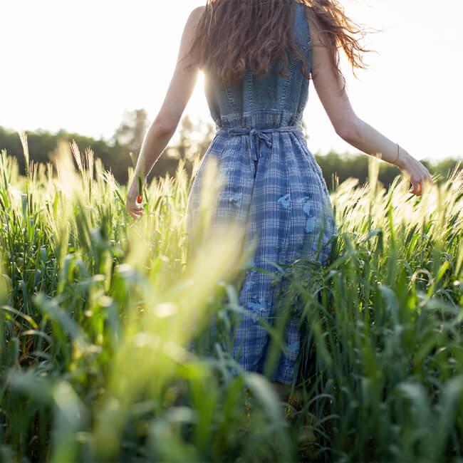 Woman walking through field